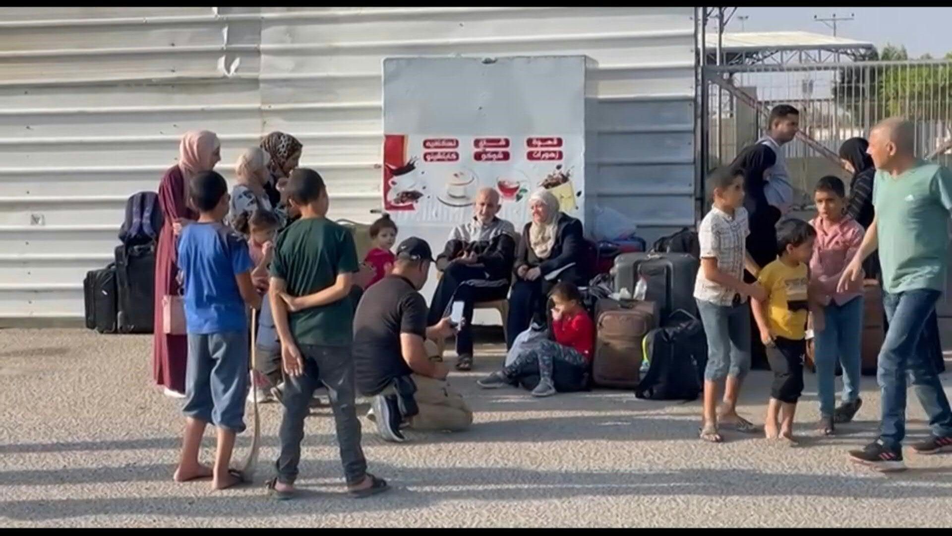 Foreigners and dual nationals wait at the Rafah border crossing