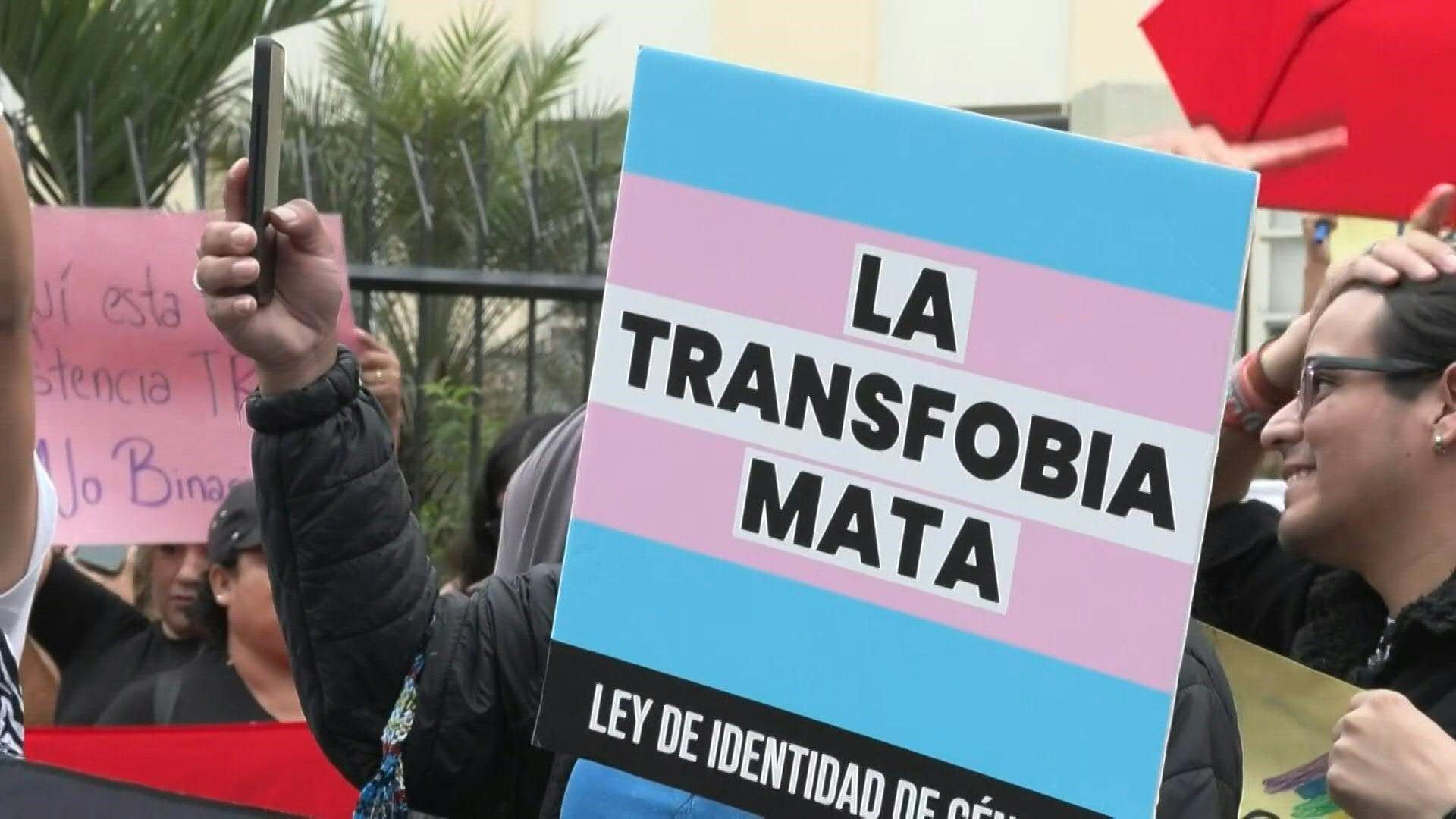 LGBTIQ+ activists march against decree describing transsexuality as 'mental disorder'