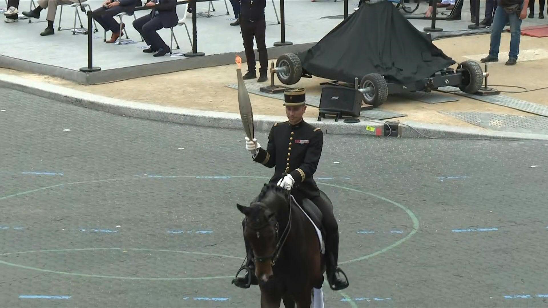 Olympic flame presented during Bastille Day parade in Paris