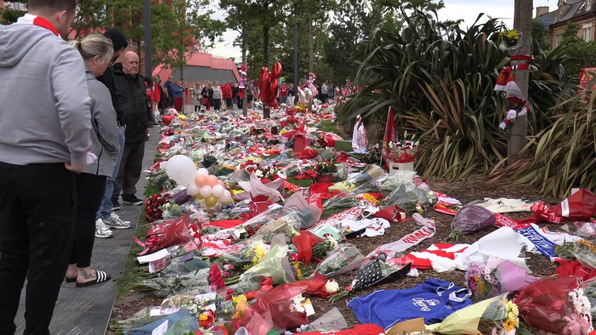 People lay flowers for Diogo Jota outside Liverpool's Anfield stadium