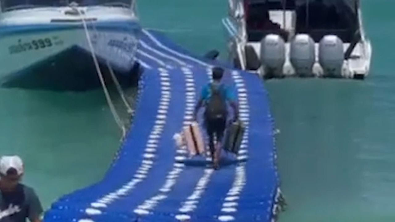 Auf den Wellen laufen: Touristen wanken über schwimmende Brücke