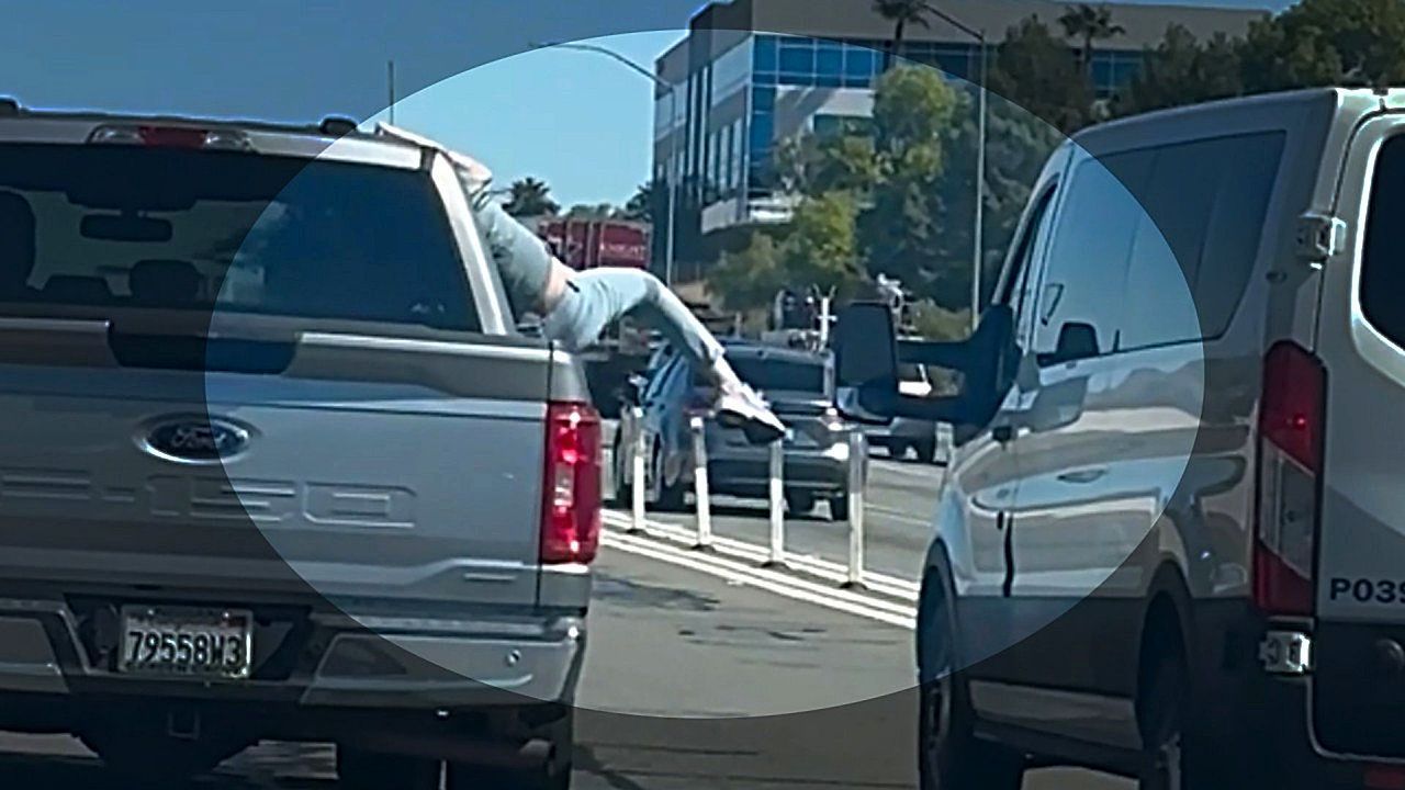 Extreme road rage! Woman kicks van while hanging out truck window