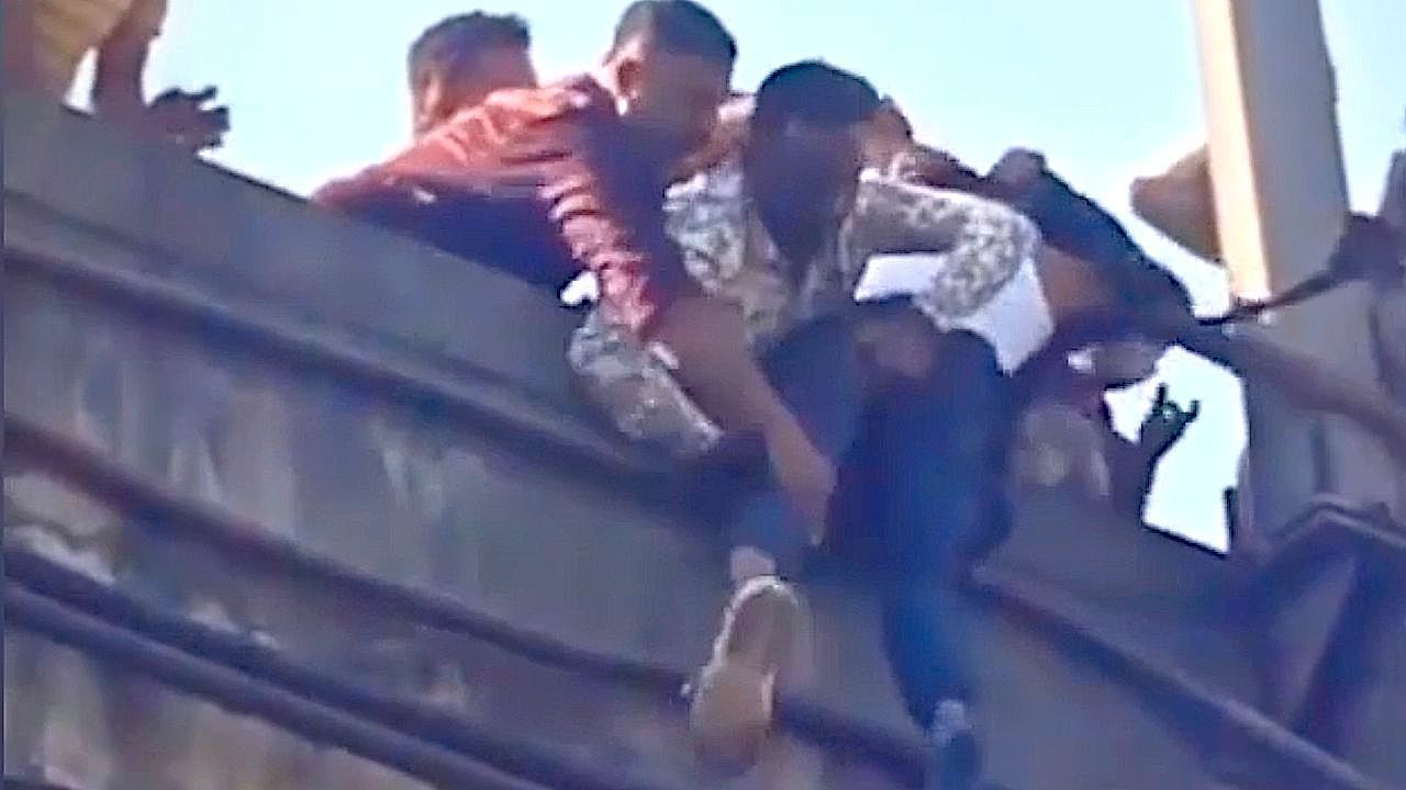 Video: Man left hanging over bridge survives after dramatic roadside rescue