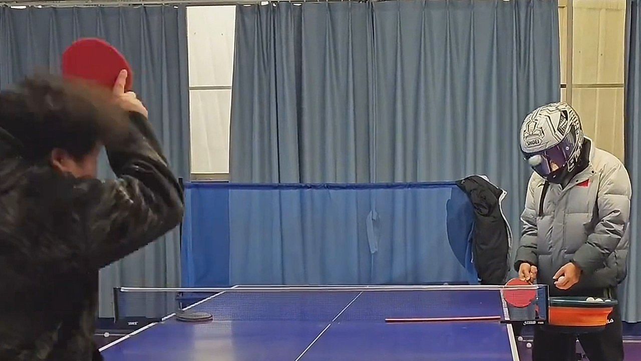 Video: The helmet takes the hit in odd table tennis rally