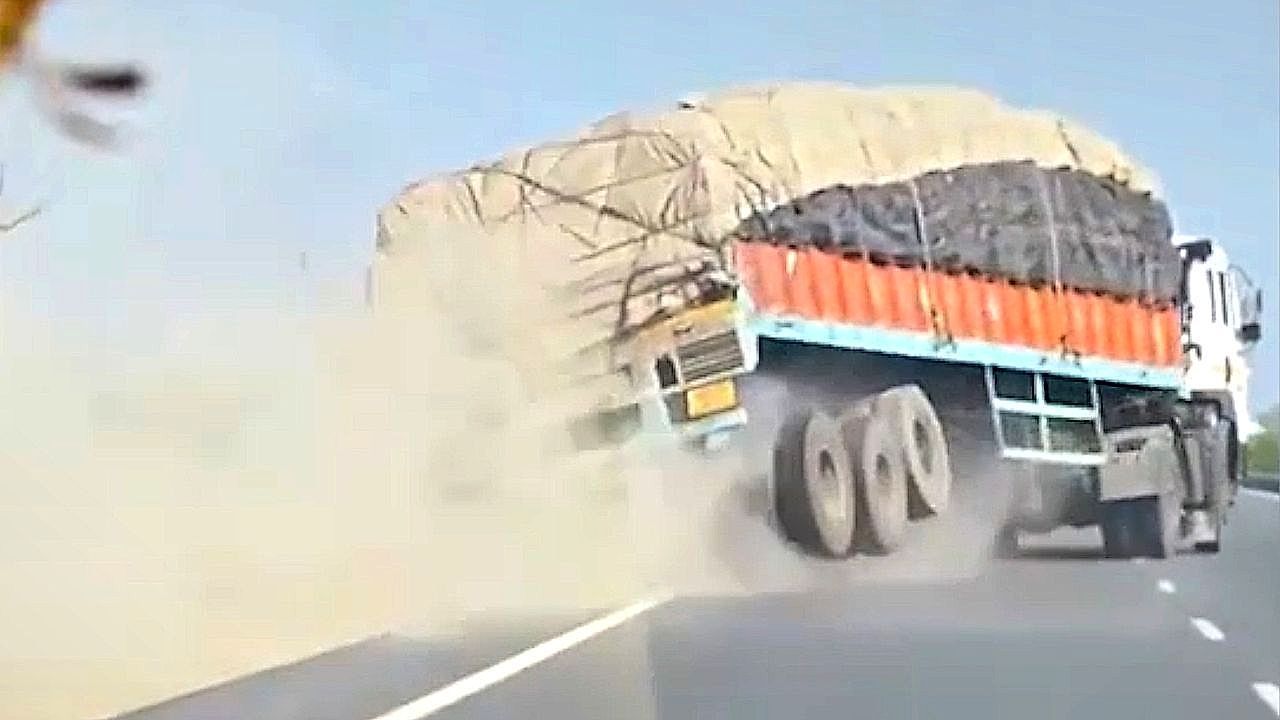 Video: Truck overturns, spilling barley across busy highway