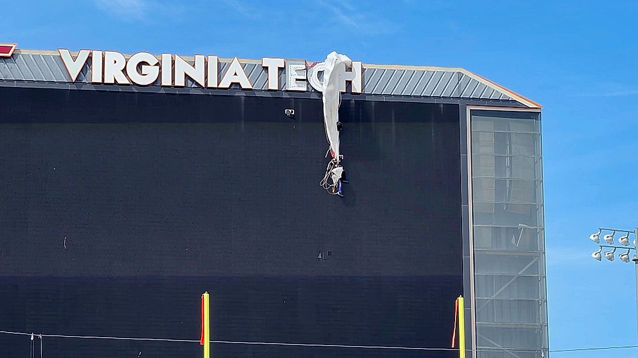 Video: Skydiver rescued after getting caught on scoreboard during Virginia Tech football game