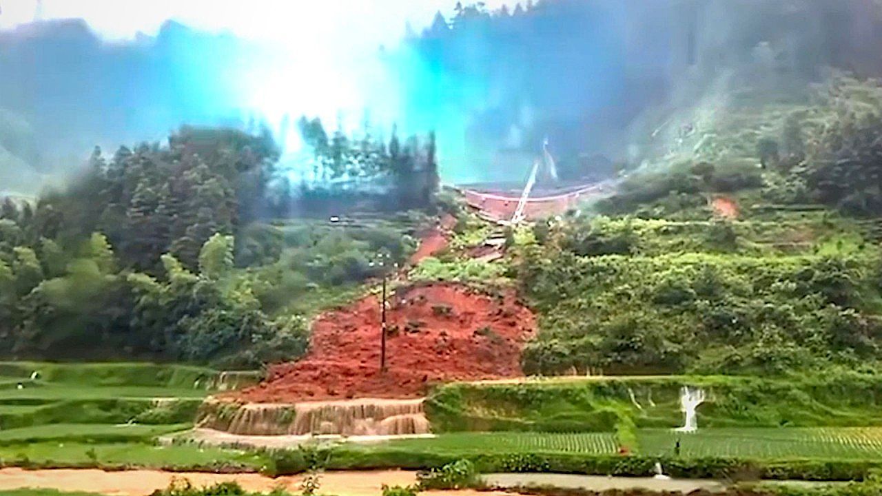 Video: Landslide sweeps through rice fields and topples live power lines in China storm