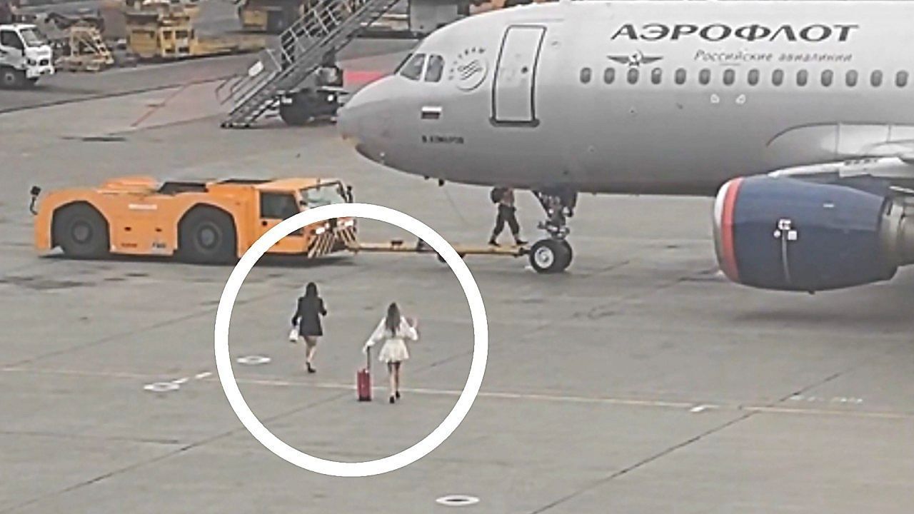Video: Two late passengers walk onto Moscow airport in bid to catch a flight