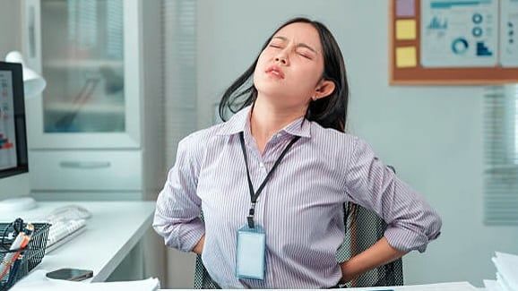 This simple sit-stand routine may help alleviate back pain in the office
